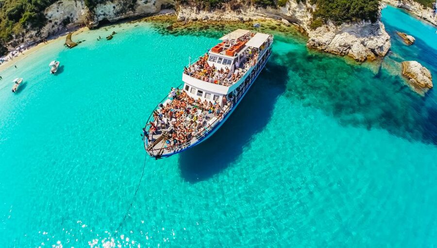 From Corfu: Day Cruise to Paxos, Antipaxos, and Blue Caves - Sailing out of Corfu: old-town views and the Ionian Sea mood